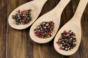 a mixture of pepper in wooden spoon