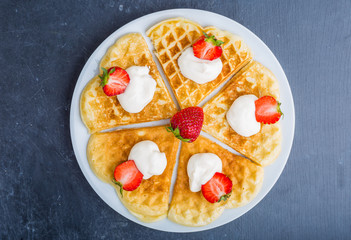 Waffles with strawberry and whipped cream