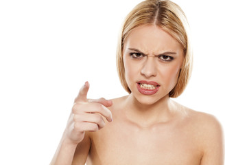 angry young woman pointing a finger at you