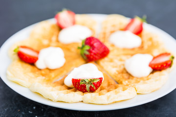 Waffles with strawberry and whipped cream