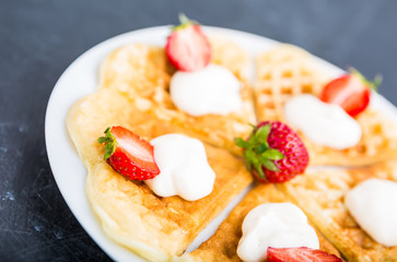 Waffles with strawberry and whipped cream