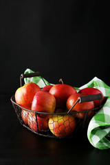 Apples in basket on black background