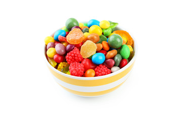 Colorful candies in bowl on white background