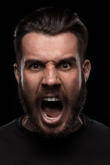 Portrait of young screaming man in studio