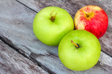 Three apples on the wood