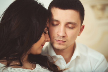 Portrait of a man and a woman face to face with eyes closed