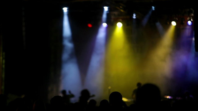 Rock concert stage with colored spotlights and smoke