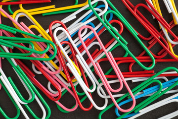 Paper clips on a black background