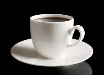 Cup of coffee with saucer on black