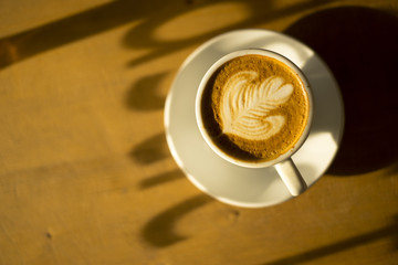 Cup of coffee latte in low light
