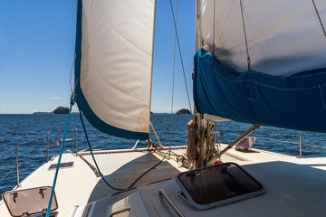 Sailing yacht catamaran cruising in the Mitsio arcipelago