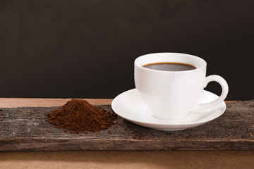 Coffee cup and Coffee powder on wood