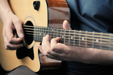 Fototapeta premium Man playing acoustic guitar