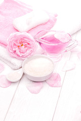 Obraz na płótnie Canvas sea salt and essential oils, pink tea rose flower. spa