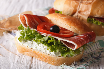 Sandwiches with prosciutto, soft cheese and vegetables