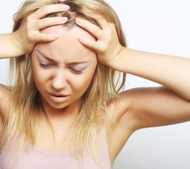 Naklejka premium blond woman with a headache holding head