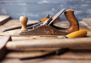 Old vintage hand tools on wooden background. Focus on jack-plane