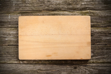 Cutting board on wooden background