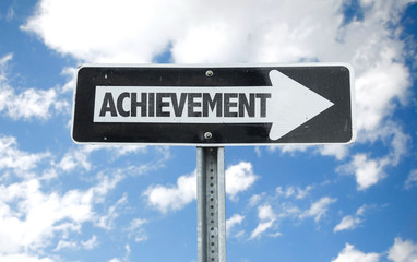 Achievement direction sign with sky background