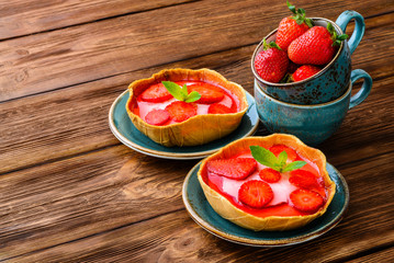 Layered dessert with fruits, cream cheese and jelly in wafer