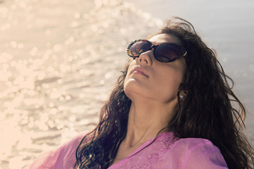 beautiful girl take a sunbathing on the seashore warm filter