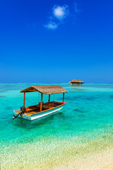 Boat and bungalow on Maldives island