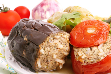 Stuffed eggplant pepper tomato cabbage leaves ground meat with rice and green on a white background