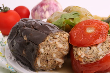 Stuffed eggplant pepper tomato cabbage leaves ground meat with rice and green on a white background