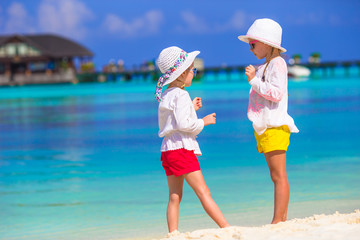 Fototapeta na wymiar Adorable little girls at beach during summer vacation