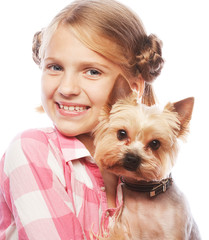 young girl smiling holding a cute puppy 