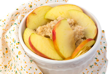 breakfast oatmeal porridge with apple in a white ceramic bowl shabby chic retro vintage health diet selective soft focus