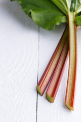 Rhubarb on white wooden table.