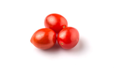 Bite sized red cherry grape tomato over white background
