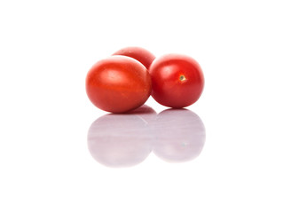 Bite sized red cherry grape tomato over white background