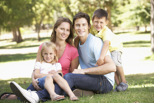 Young Family Sitting in Park