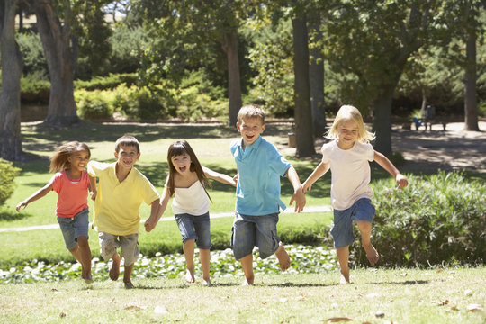 Group Of Children Running In Park