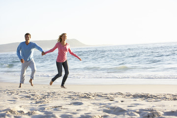 Young Couple Having Fun On Sandy Beach