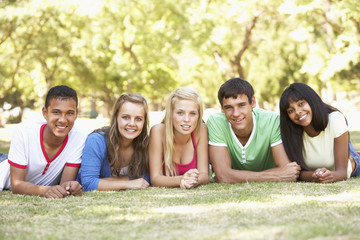 Group Of Teenage Friends Relaxing In Park Together