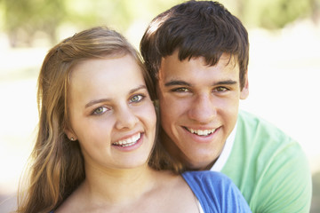Naklejka premium Teenage Couple Having Fun In Park Together