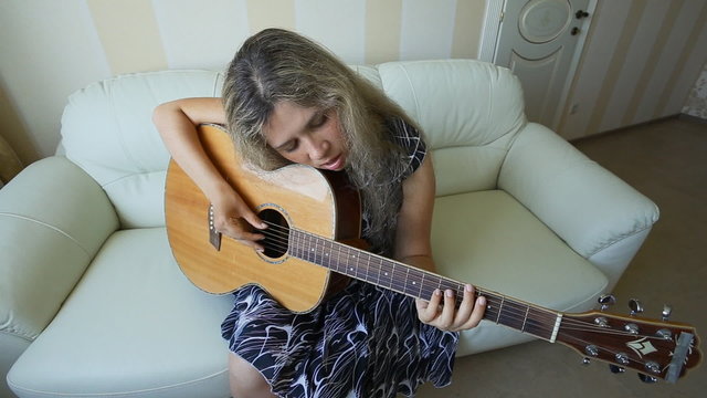 girl with guitar at home