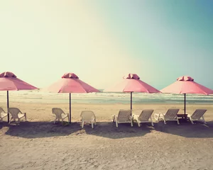 Retro beach with pink umbrellas © Andreka Photography