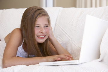 Obraz na płótnie Canvas Young Girl Using Laptop At Home