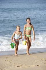 Naklejka premium Two Young Girls Enjoying Beach Holiday