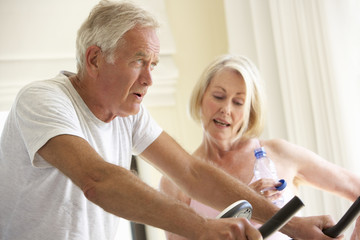 Senior Couple On Exercise Bike