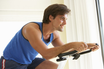 Fototapeta na wymiar Young Man On Exercise Bike
