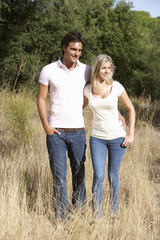 Young Couple Walking Through Summer Countryside