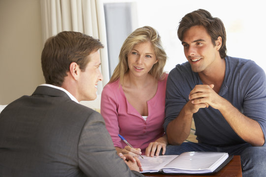 Couple Meeting With Financial Advisor At Home