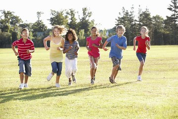 Obraz na płótnie Canvas Group Of Children Running Through Countryside