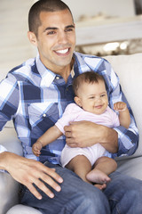 Obraz premium Young Father On Sofa At Home