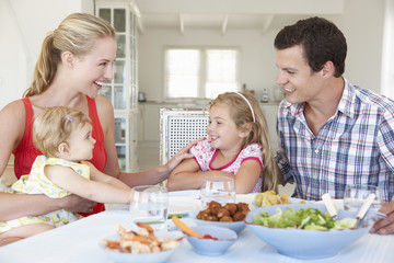 Obraz na płótnie Canvas Family Enjoying Meal Together At Home